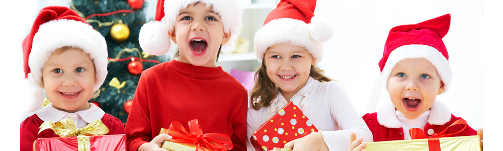 Group of four children in Christmas hat with presents; Shutterstock ID 89220517; PO: purchase_order4; Job: job1; Client: client2; Other: other3